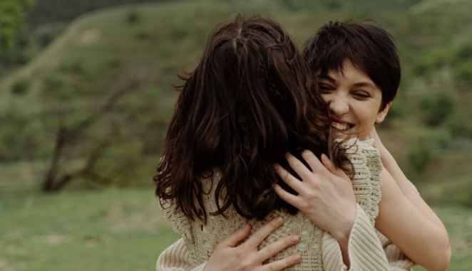 two friends embrace joyfully
