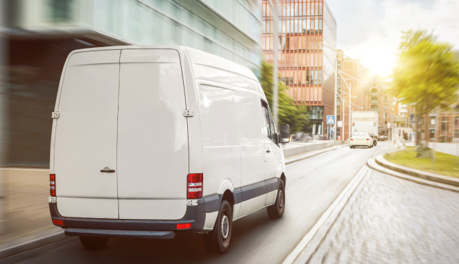 a van drives through a city